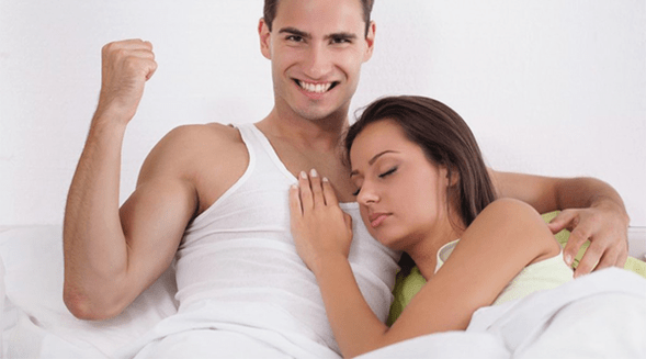 a woman in bed with a man with increased potency